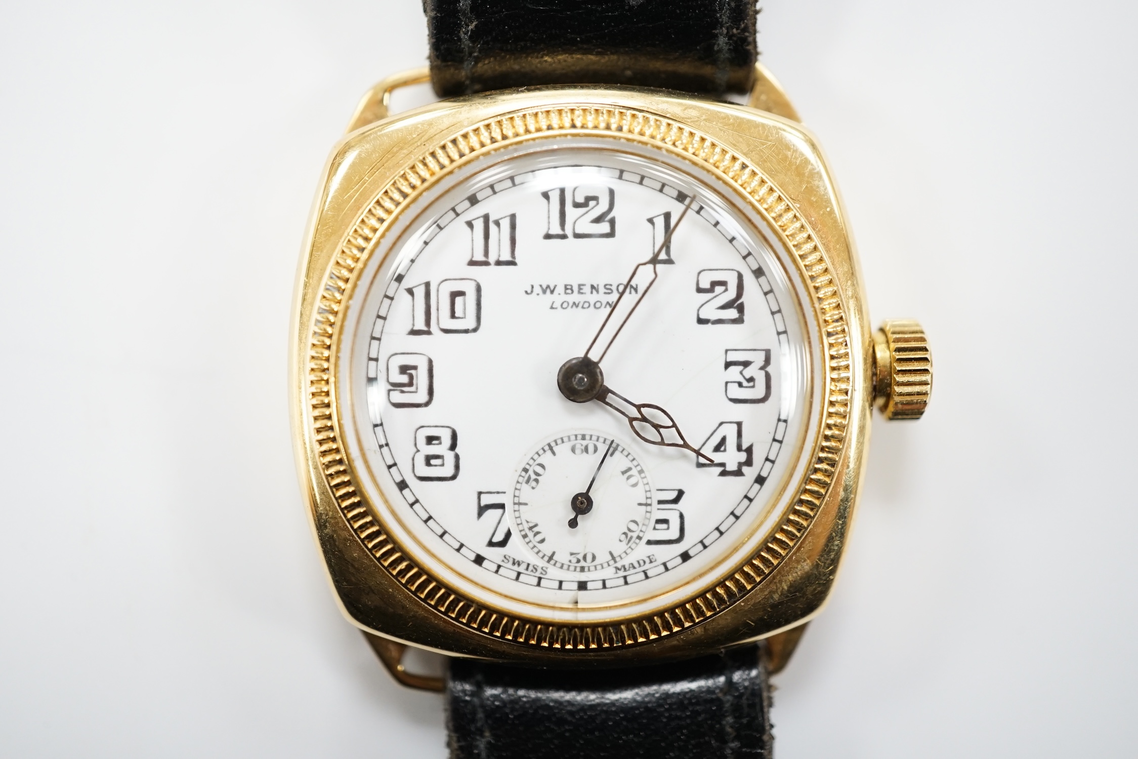 A gentleman's yellow metal J.W. Benson manual wrist watch, with Arabic dial and subsidiary seconds, on a black leather strap.